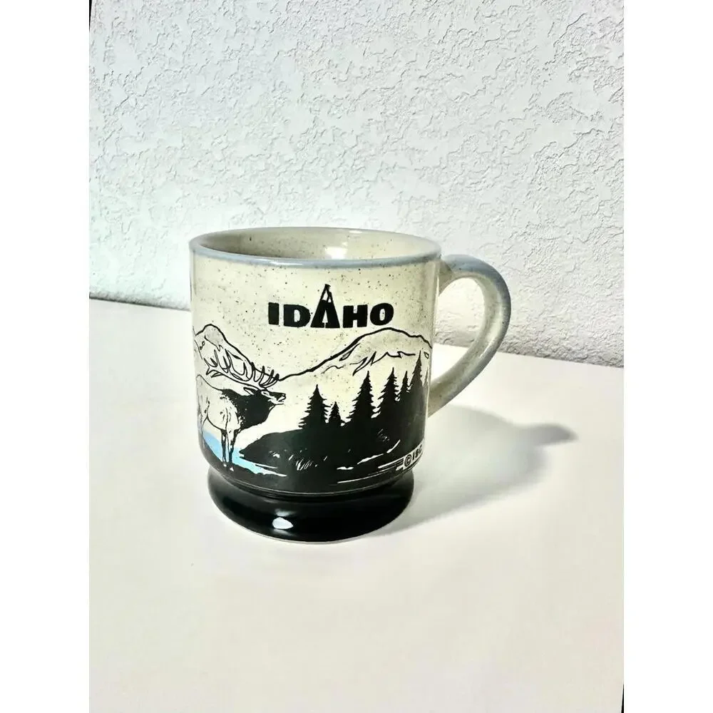 ISC Vintage Tan Speckled Idaho State Souvenir Coffee Mug Elk and Mountains Theme